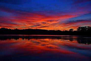 Paquis pond at sunset, reflections on the water, Brognard, Doubs, France