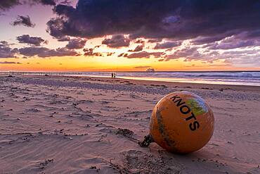 Buoy stranded on the beach of Sangatte, at sunset, Hauts de France