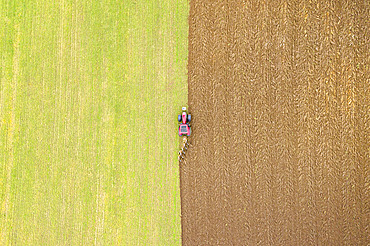 Ploughing a field seen from the sky in autumn, Pas-de-Calais, Opal coast, France