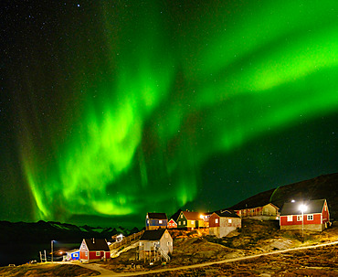 Northern Lights over settlement Kuummiit (formerly spelled Kummiut). Ammassalik area in East Greenland. North America, Greenland, Danish Territorrry