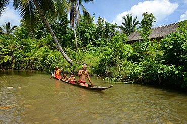 Mentawai familly on dugout, Siberut, Indonesia