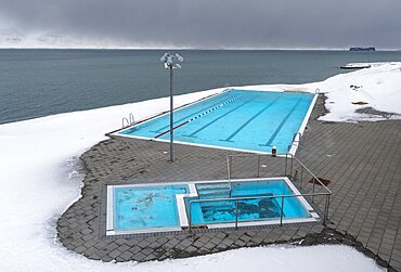 Hofsos at Skagafjoerdur during winter, Iceland. Hofsos, a traditional fishing village with many historic buildings on the coast of Skagafjoerdur during winter. The municipal swimming pool. europe, northern europe, iceland, March