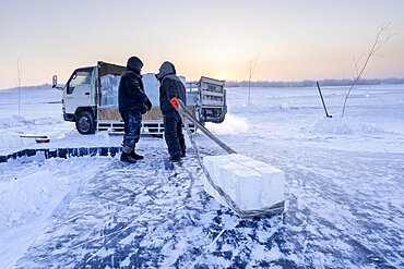 Extraction of ice cube from the Lena river for use as drinking water by residents without access to running water, Yakutsk, Republic of Sakha, Russia