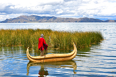 Aymara on their Totora boat (Schoenoplectus californicus subsp. tatora). Lake Titicaca, Bolivia