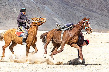 Riders at a game of Kok-boru (or Ulak-tartish or Buzkachi), Central Asian equestrian games at the Noorus festival, Kotchkor, Naryn Region, Kyrgyzstan