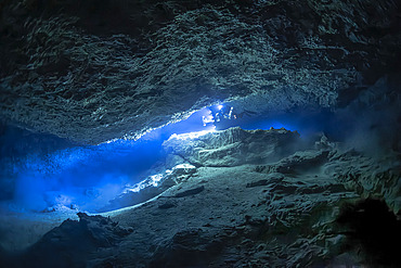 Potholing diver in a karstic cave at Passe Bateau Sud, 60 metres deep in Mayotte's lagoon.