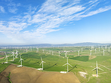 Windmills on a wind farm near Zahara de los Atunes. Aerial view. Drone shot. Cádiz province, Andalusia, Spain.