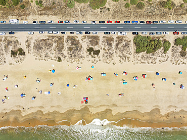 Beach life at the Atlantic Ocean near Punta Umbria. Aerial view. Drone shot. Huelva province, Andalusia, Spain.