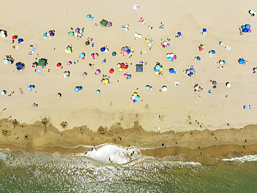 Beach life at the Atlantic Ocean near Punta Umbria. Aerial view. Drone shot. Huelva province, Andalusia, Spain.