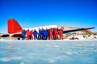 The expeditionaries bound for Cap Prud'Homme and Dumont d'Urville, in front of the Basler that will take them there. It's worth noting that some of them are wearing the blue garment normally worn for Concordia: this is because it's warmer and contains more down, which is no luxury at the start of the summer season. A matter of habit and personal preference. The buildings of the Mario Zucchelli base can be seen in the background. Terra Nova Bay, Victoria Land, Antarctica