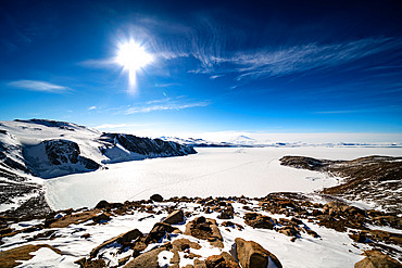 General view of Terra Nova Bay. In the distance, the summer airstrip. In the background, Mount Melbourne. On the right, the Mario Zucchelli base. Victoria Land, Antarctica