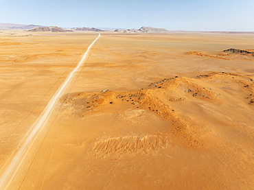 The C14 gravel road at the edge of the Namib Desert. Aerial view. Drone shot. Namibia.