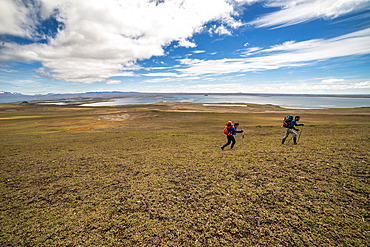 Alexia and Arthur. Two scientists walk from the Port-aux-Francais base to the Pointe Suzanne hut. Kerguelen Islands