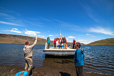 The barge "L'Aventure II" drops off a small team of technicians for several days at Halage des Naufrages, to carry out renovation work on the Phonolite refuge. Kerguelen Islands