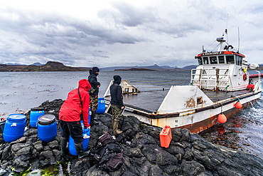 The barge L'Aventure II drops off a team of scientists on Mayes Island for a week-long ornithological mission. Mayes Island, Gulf of Morbihan. Kerguelen Archipelago.