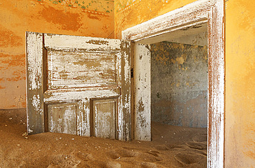 At Kolmanskop, the abandoned ghost town of the diamond days of the early 1900 and of German origin. Inside the restricted Diamond Area east of the coastal town of Luederitz. Namib Desert, Namibia.