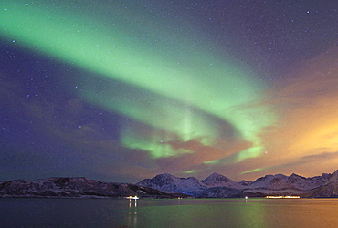 meteorology northern lights over landscape coast with mountains snow covered sky with stars