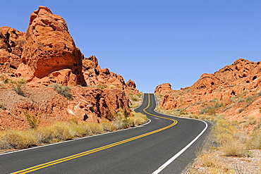 road through landscape with rock formations