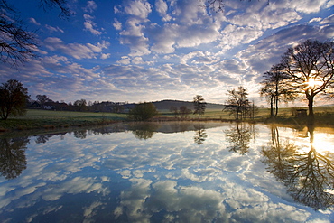 lake sun sky and clouds mirroring on the water surface of a lake Jocketa Vogtland Saxony Germany Nature Scenery