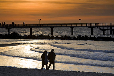 pier of Wustrow at dusk Baltic Sea people 02 walking on beach sunset nature mood Mecklenburg-Vorpommern Germany