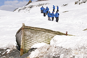 tourists and historic whaling boat on island beach