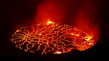 volcano Nyiragongo crater with lava fountains in the lava lake rising smoke nature natural phenomenon night view