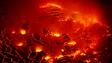 volcano Nyiragongo crater with lava fountains in the lava lake rising smoke nature natural phenomenon night view