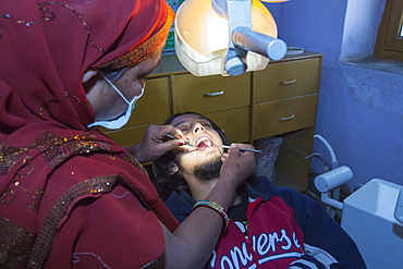 A Barefoot Dentist, who is trained to perform basic dentistry at the Barefoot College in Tilonia, Rajasthan, India. The Barefoot College is a worldwide charity, founded by Bunker Roy, its aims are, education, drinking water, electrification through solar power, skill development, health, women empowerment and the upliftment of rural people.