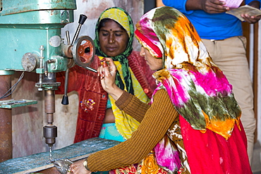 Women building solar cookers at the Barefoot College in Tilonia, Rajasthan, India. The Barefoot College is a worldwide charity, founded by Bunker Roy, its aims are, education, drinking water, electrification through solar power, skill development, health, women empowerment and the upliftment of rural people.