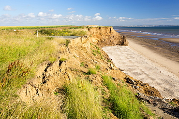 A collapsed coastal road at near Aldbrough on Yorkshires East Coast, near Skipsea, UK. The coast is composed of soft boulder clays, very vulnerable to coastal erosion. This sectiion of coast has been eroding since Roman times, with many villages having disappeared into the sea, and is the fastest eroding coast in Europe. Climate change is speeding up the erosion, with sea level rise, increased stormy weather and increased heavy rainfall events, all palying their part.