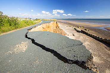 A collapsed coastal road at between Skipsea and Ulrome on Yorkshires East Coast, near Skipsea, UK. The coast is composed of soft boulder clays, very vulnerable to coastal erosion. This sectiion of coast has been eroding since Roman times, with many villages having disappeared into the sea, and is the fastest eroding coast in Europe. Climate change is speeding up the erosion, with sea level rise, increased stormy weather and increased heavy rainfall events, all palying their part.