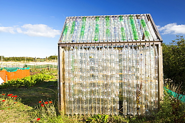 A greenhouse made from waste plastic drinks bottles in the community garden at Mount Pleasant Ecological Park, Porthtowan, Cornwall, UK.