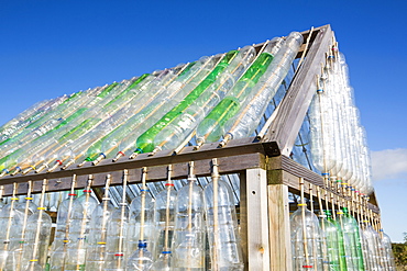 A greenhouse made from waste plastic drinks bottles in the community garden at Mount Pleasant Ecological Park, Porthtowan, Cornwall, UK.