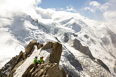 Mont Blanc from the Aiguille Du Midi above Chamonix, France, with climbers on the Cosmiques Arete.