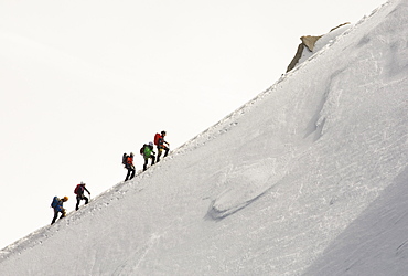 Climbers on the arete leading up from the Vallee Blanche to the Aiguille Du Midi above Chamonix, France.