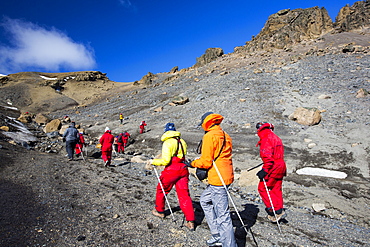 Passengers on an expedition cruise climbing the caldera on Deception Island in the South Shetland Islands off the Antarctic Peninsular which is an active volcanic.