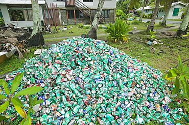 Beer cans piled up in a garden on Funafuti Atoll, Tuvalu, Pacific