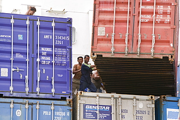 Tuvaluan workers loading containers on the supply ship for Funafuti Atoll, Tuvalu, Pacific