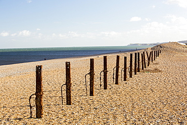 Second World war defences that for a long time were buried under the storm beach are revealed after the December 2013 storm surge at Cley on the North Norfolk coast, UK. The huge waves completely breached the storm beach, and pushed it inland onto the Cley nature reserve.