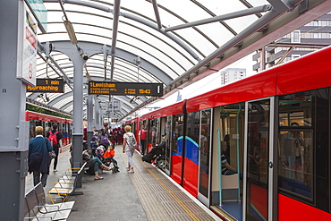 A Docklands Light Railway train (DLR) at a station near Canary wharf, London, UK.