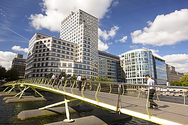 A bridge over docklands towards Canary wharf, London, UK.