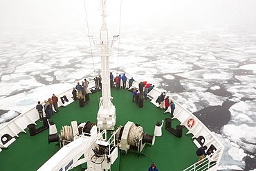 The Russian research vessel, AkademiK Sergey Vavilov an ice strengthened ship on an expedition cruise to Northern Svalbard, with clients on the prow at over 80 degrees north in rotten sea ice, some 550 miles from the North Pole. Latest research shows the Arctic will be ice free in the summer by around 2054.