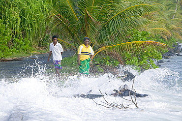 Tuvaluans watch as the high tide inundates their island home due to global warming induced sea level rise, Funafuti, Tuvalu, Pacific