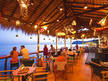 A seafront cocktail bar in Skala Eresou, Lesbos, Greece at sunset.