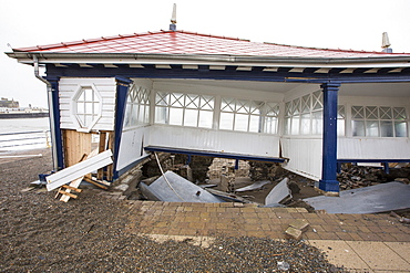 After a week of high tides, storm surges and storm force winds, the sea front promenade of Aberystwyth in Wales has been devastated, with millions of Â£'s of damage. The crsahing waves punched a large hole in the sea wall and has collapsed Aberystwyth's iconic, Victorian promenade shelter, which has stood for over 100 years. This picture was taken on Wednesday 8th January, 2014, the day the council started to try and clear the thousands of tonnes of beach rubble off the sea front road.