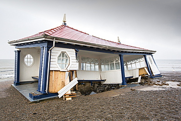 After a week of high tides, storm surges and storm force winds, the sea front promenade of Aberystwyth in Wales has been devastated, with millions of Â£'s of damage. The crsahing waves punched a large hole in the sea wall and has collapsed Aberystwyth's iconic, Victorian promenade shelter, which has stood for over 100 years. This picture was taken on Wednesday 8th January, 2014, the day the council started to try and clear the thousands of tonnes of beach rubble off the sea front road.