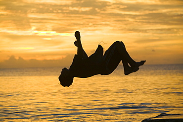 Tuvaluan children leaping into the sea on Funafuti Atoll, Tuvalu, Pacific