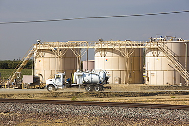 A fracking site being fracked near Wasco in California's Central Valley, USA. Fracking for natural gas and oil, has reduced energy prices in the US, but fracking is a water hungry industry, that competes directly with the agricultural sector for water. After a 4 year long drought water is running out.  Fracking also contaminates ground water supplies from all the chemicals that are pumped underground to frack the fossil fuel bearing rocks.