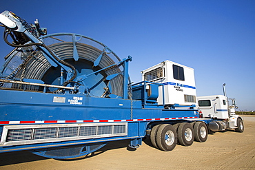 A fracking truck next to a site being fracked near Wasco in California's Central Valley, USA. Fracking for natural gas and oil, has reduced energy prices in the US, but fracking is a water hungry industry, that competes directly with the agricultural sector for water. After a 4 year long drought water is running out.  Fracking also contaminates ground water supplies from all the chemicals that are pumped underground to frack the fossil fuel bearing rocks.