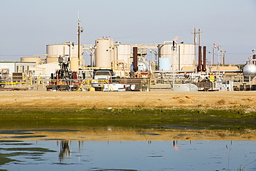 A fracking site being fracked near Wasco in California's Central Valley, USA. Fracking for natural gas and oil, has reduced energy prices in the US, but fracking is a water hungry industry, that competes directly with the agricultural sector for water. After a 4 year long drought water is running out.  Fracking also contaminates ground water supplies from all the chemicals that are pumped underground to frack the fossil fuel bearing rocks.